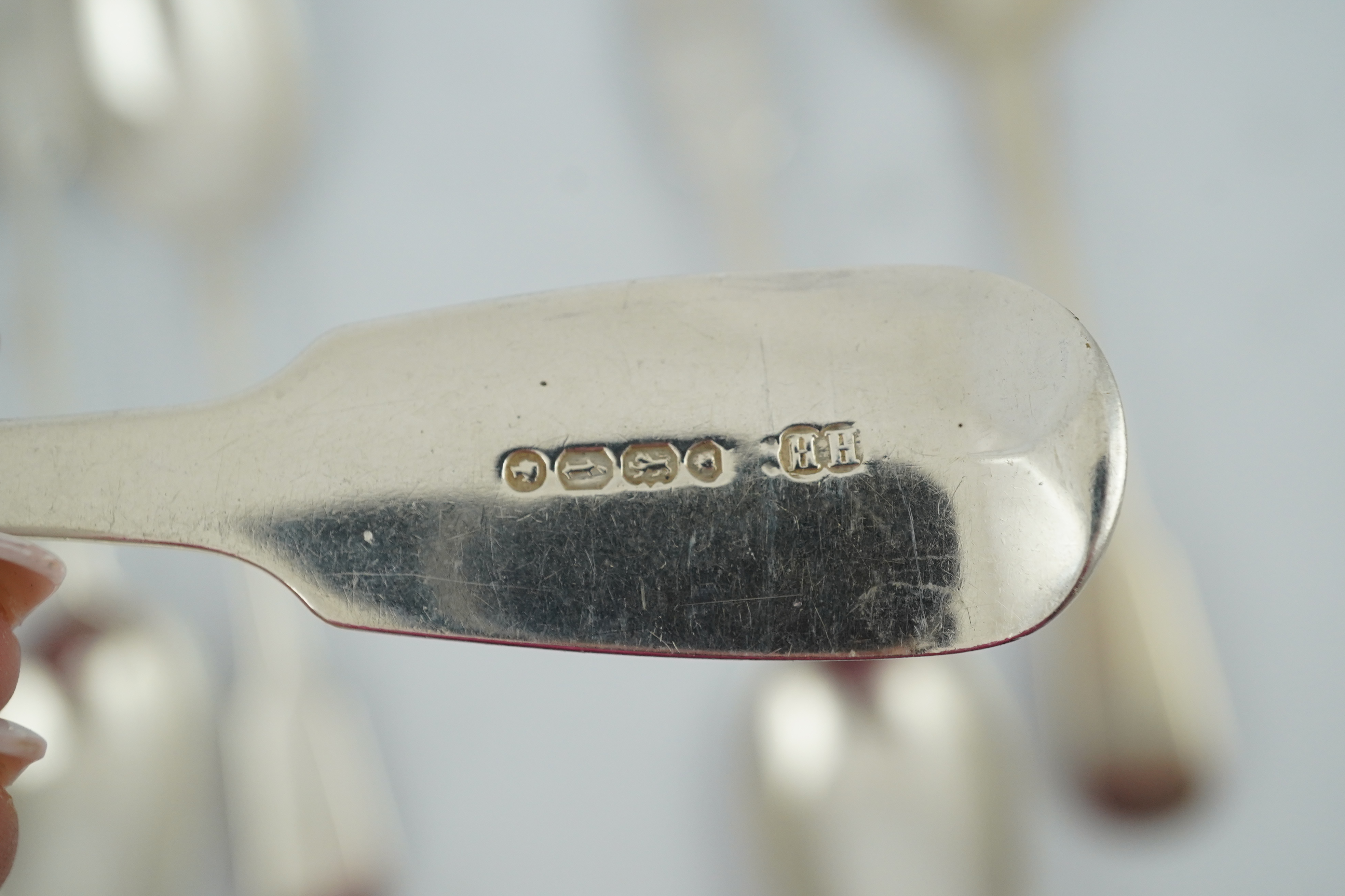 A matched set of seven late Victorian silver table spoons by Goldsmiths & Silversmiths Co Ltd (5) and Francis Higgins (2), London, 1894, together with a similar silver sauce ladle, two earlier silver table spoons and a W